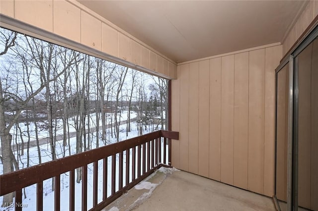 view of snow covered back of property