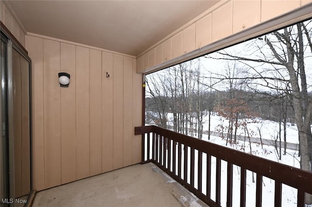 view of snow covered back of property