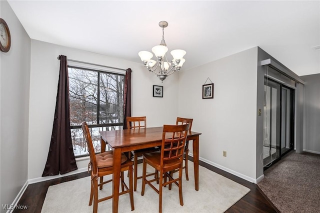 dining space featuring a notable chandelier and dark wood-type flooring