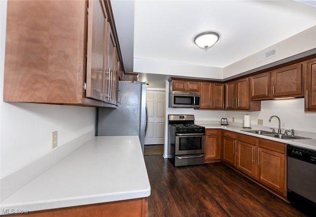 kitchen featuring sink, dark wood-type flooring, and appliances with stainless steel finishes