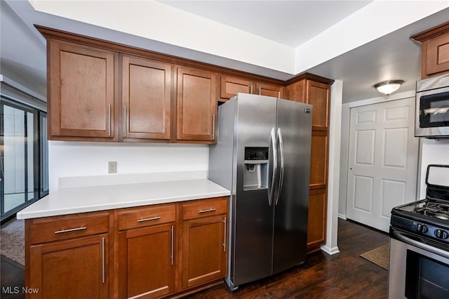 kitchen with stainless steel appliances and dark hardwood / wood-style flooring