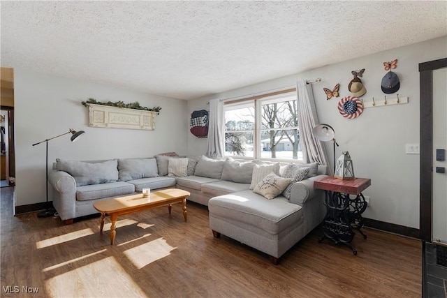 living room featuring a textured ceiling and dark hardwood / wood-style floors