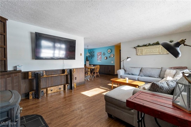 living room featuring a textured ceiling and wood-type flooring