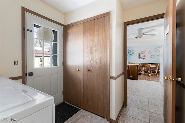 laundry area with washer / dryer, ceiling fan, and light tile patterned floors