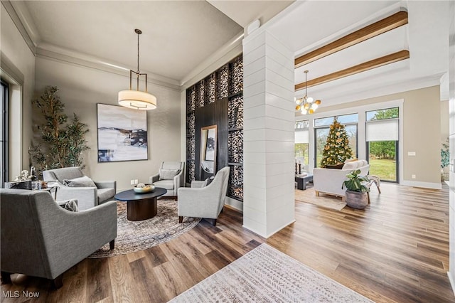 interior space with hardwood / wood-style floors, an inviting chandelier, and crown molding