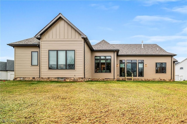 rear view of property with a lawn