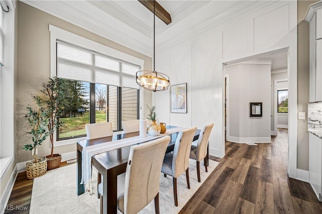 dining room featuring dark hardwood / wood-style floors, a chandelier, crown molding, and beamed ceiling