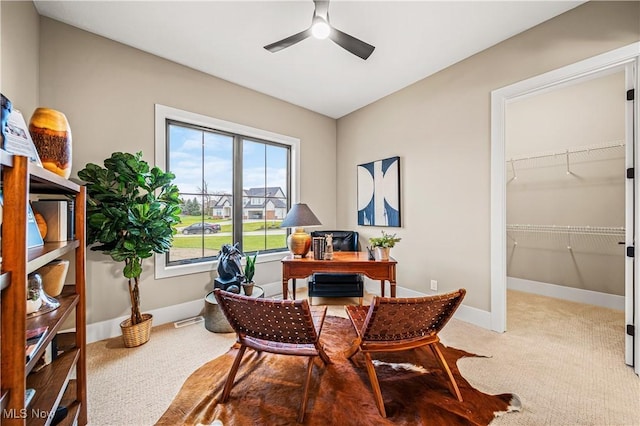 carpeted home office featuring ceiling fan