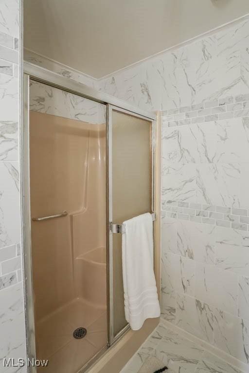 bathroom with a shower with door