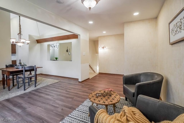 living room with dark wood-type flooring and a chandelier