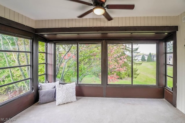 unfurnished sunroom featuring ceiling fan