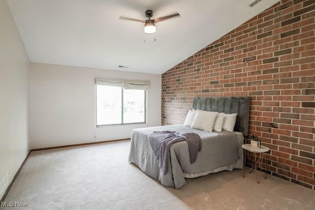 carpeted bedroom featuring brick wall, ceiling fan, and vaulted ceiling