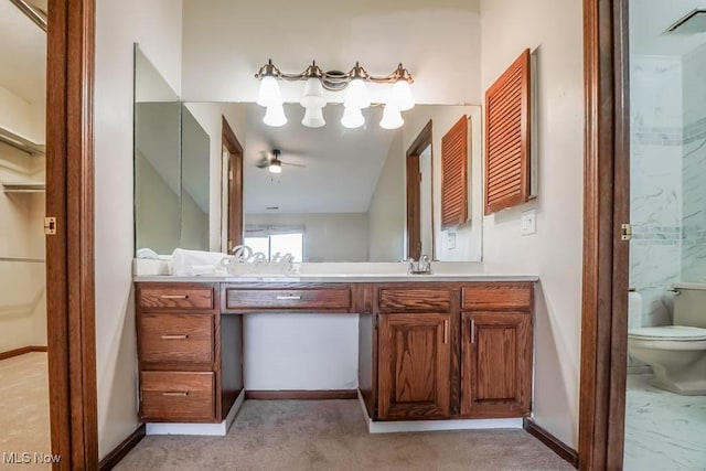 bathroom with toilet, ceiling fan, and vanity