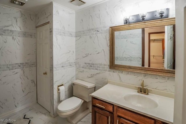 bathroom featuring tile walls, toilet, and vanity