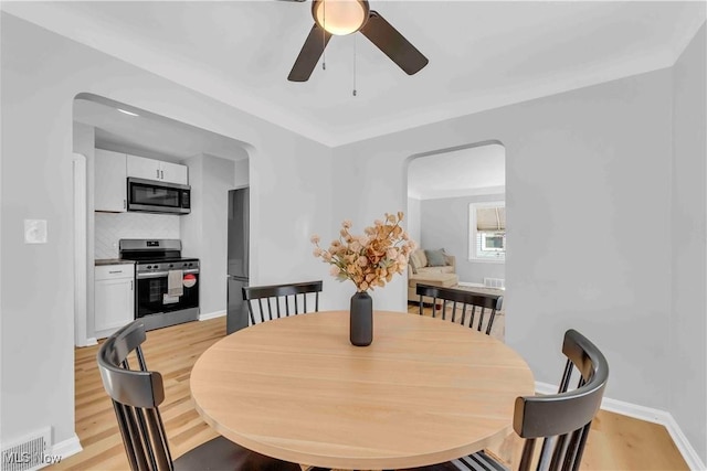 dining space featuring ceiling fan and light hardwood / wood-style floors