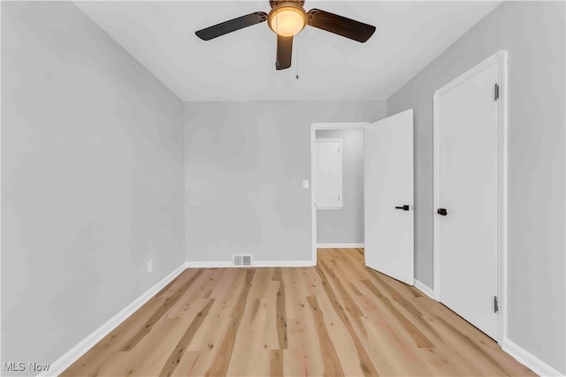 spare room with light wood-type flooring and ceiling fan