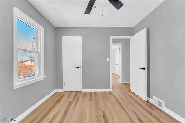 unfurnished bedroom with ceiling fan and light hardwood / wood-style floors