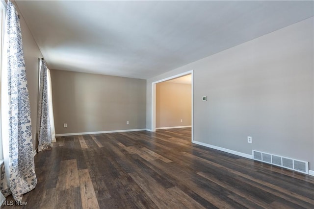 unfurnished room featuring dark hardwood / wood-style floors