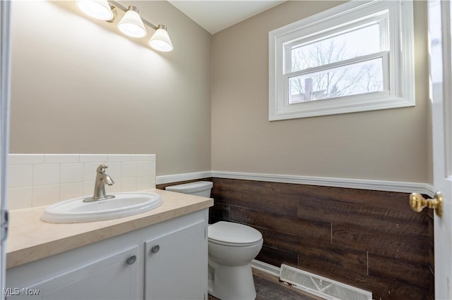 bathroom featuring toilet and vanity