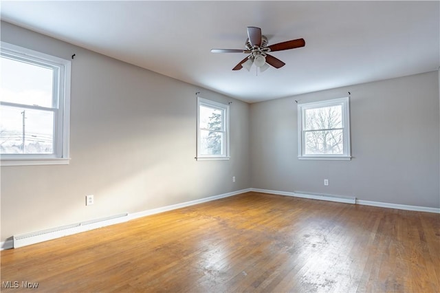 empty room featuring ceiling fan, a baseboard radiator, and wood-type flooring