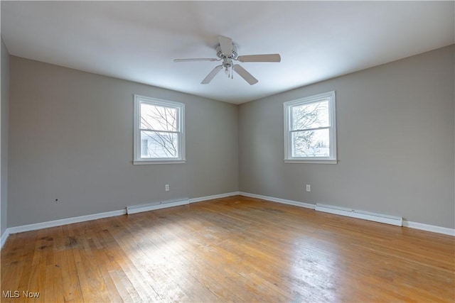 empty room with ceiling fan, baseboard heating, and light hardwood / wood-style flooring