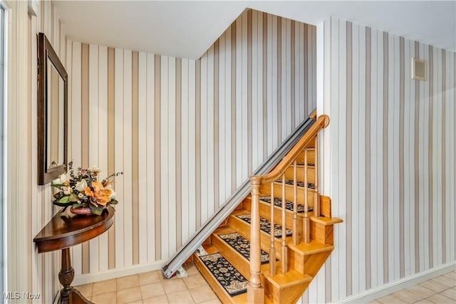 staircase featuring tile patterned floors