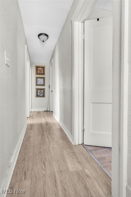 corridor with light wood-type flooring