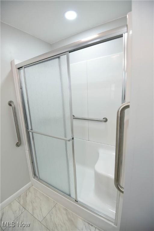 bathroom with a shower with door