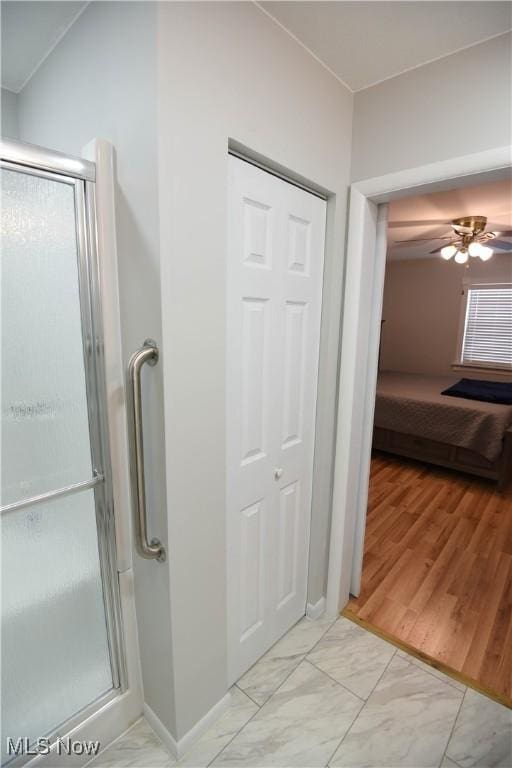 bathroom featuring ceiling fan and walk in shower