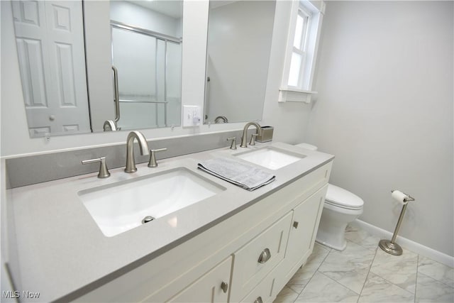 bathroom featuring toilet, an enclosed shower, and vanity