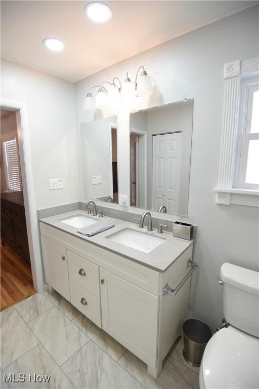 bathroom featuring toilet and vanity