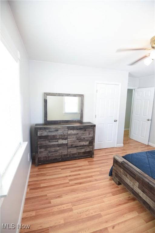 bedroom with ceiling fan and light wood-type flooring