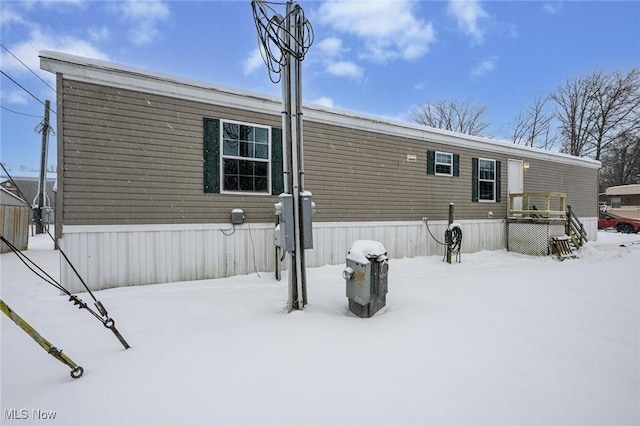 view of snow covered rear of property