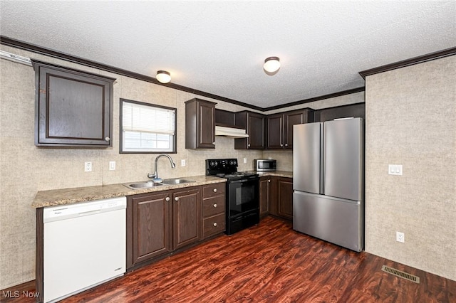 kitchen with sink, appliances with stainless steel finishes, a textured ceiling, ornamental molding, and dark wood-type flooring