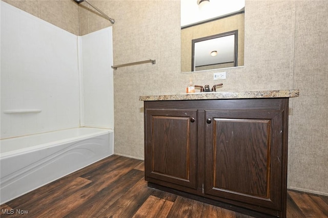 bathroom featuring tub / shower combination, vanity, and hardwood / wood-style flooring