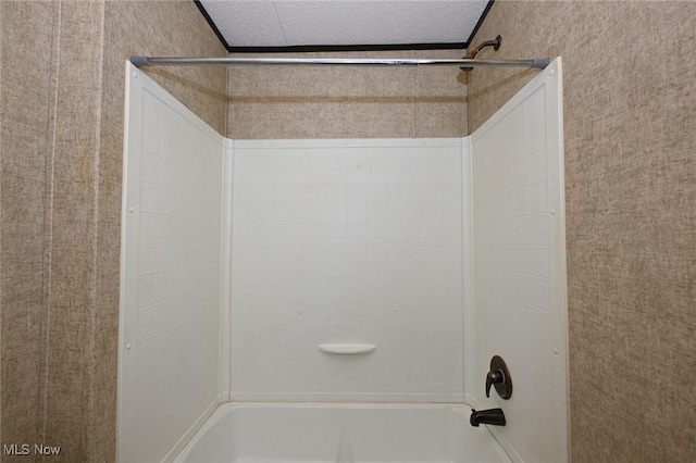 bathroom featuring a textured ceiling and shower / bath combination