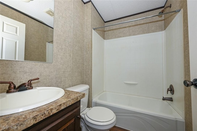 full bathroom featuring a textured ceiling, toilet, shower / washtub combination, vanity, and crown molding