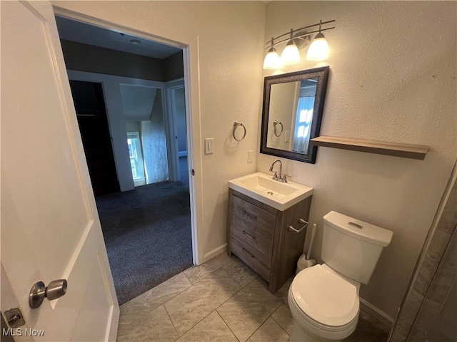 bathroom with toilet and vanity