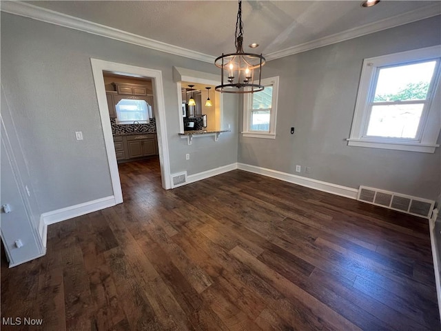 unfurnished dining area with an inviting chandelier, a wealth of natural light, and dark hardwood / wood-style flooring