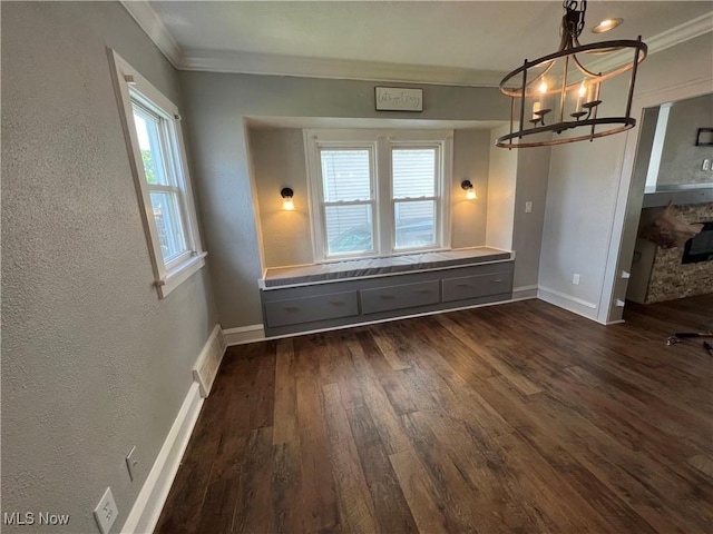 unfurnished dining area with a chandelier, crown molding, and dark hardwood / wood-style floors