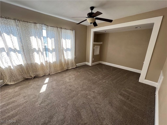 carpeted spare room featuring ceiling fan