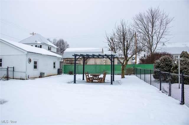 snowy yard with a pergola