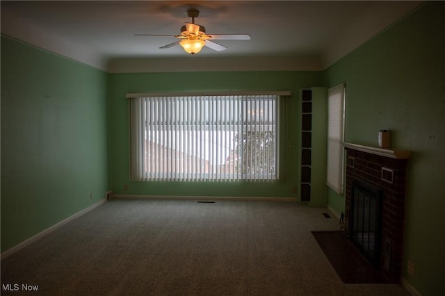 unfurnished living room featuring a brick fireplace, ceiling fan, and carpet flooring