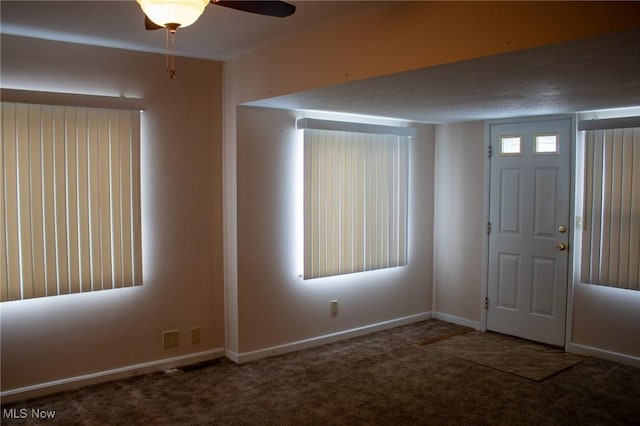 entrance foyer with carpet floors and ceiling fan