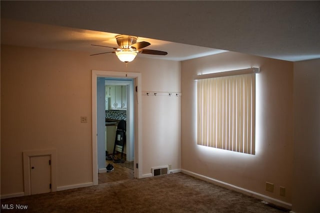 empty room with ceiling fan and carpet flooring