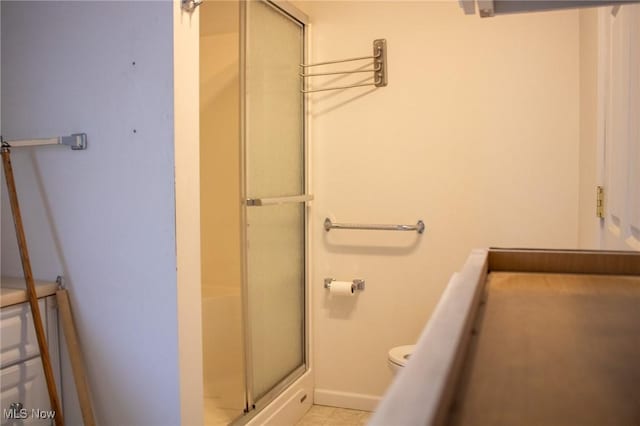 bathroom featuring toilet and an enclosed shower