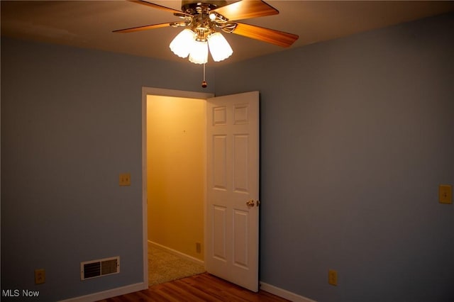 unfurnished room featuring ceiling fan and hardwood / wood-style floors