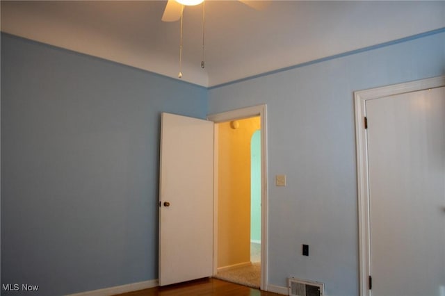 empty room with hardwood / wood-style floors and ceiling fan