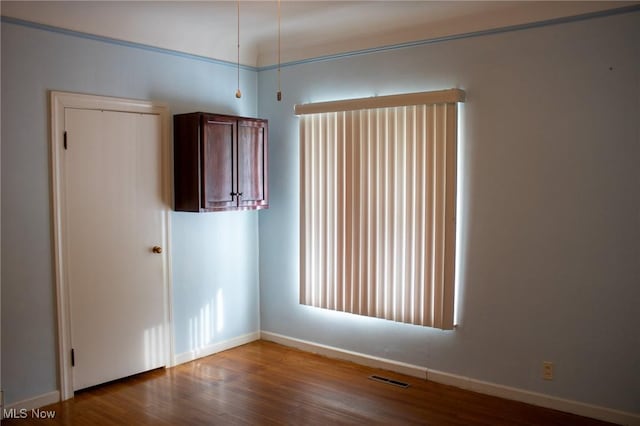 spare room with wood-type flooring