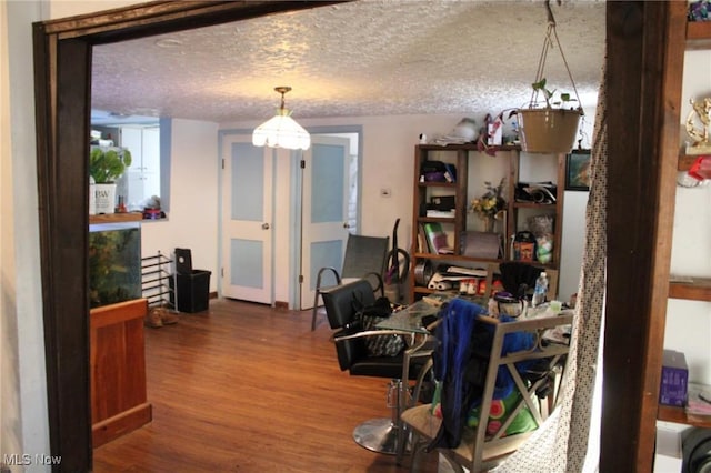 interior space featuring a textured ceiling and hardwood / wood-style flooring